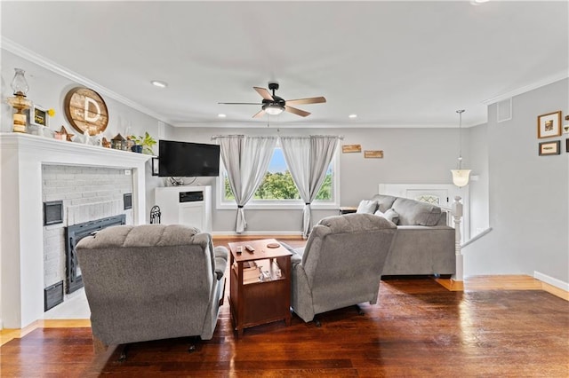 10708 E 301st St, Drexel, MO 64742 - living room with ceiling fan, wood finished floors, a brick fireplace, ornamental molding, and recessed lighting