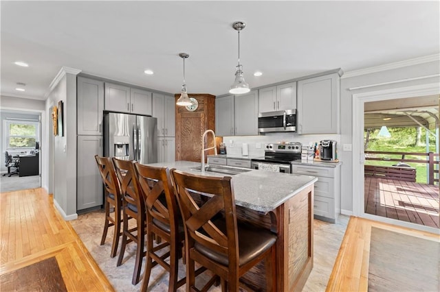 10708 E 301st St, Drexel, MO 64742 - kitchen with stainless steel appliances, gray cabinets, crown molding, light wood finished floors, and recessed lighting