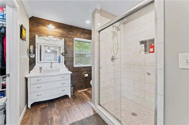 10708 E 301st St, Drexel, MO 64742 - bathroom featuring wood-type flooring, a shower stall, vanity, crown molding, and wooden walls