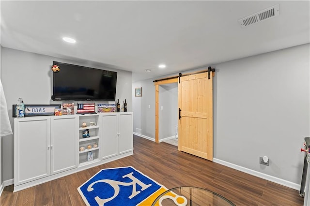 10708 E 301st St, Drexel, MO 64742 - rec room featuring a barn door, recessed lighting, and dark wood-style flooring