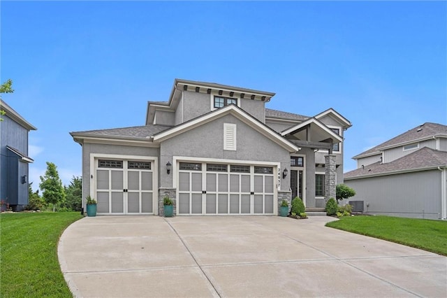 24957 W 98th St, Lenexa, KS 66227 - view of front of home with a front lawn, concrete driveway, stucco siding, and a garage