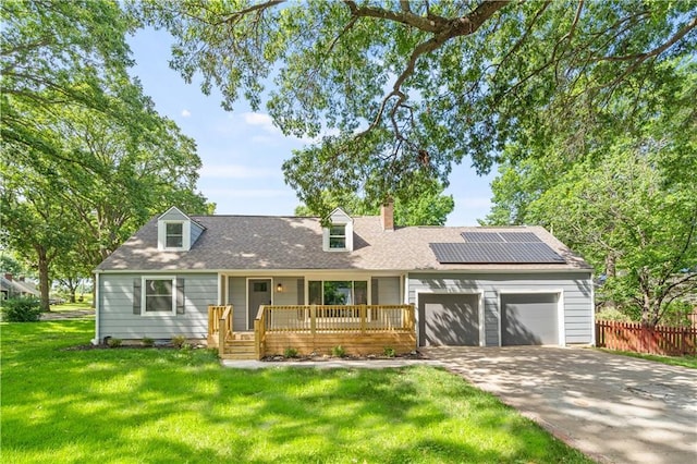 4301 W 74th St, Prairie Village, KS 66208 - cape cod house with a garage, roof mounted solar panels, driveway, a chimney, and a shingled roof