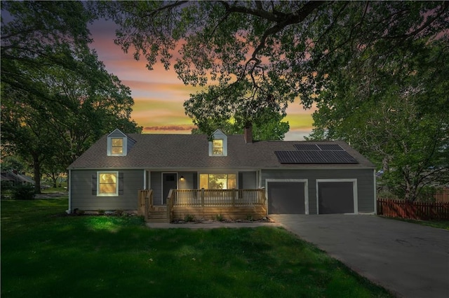 4301 W 74th St, Prairie Village, KS 66208 - view of front of home featuring a porch, an attached garage, roof mounted solar panels, asphalt driveway, and a chimney