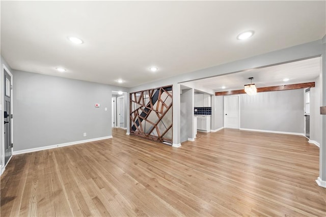 4301 W 74th St, Prairie Village, KS 66208 - unfurnished living room with light wood-style flooring and recessed lighting