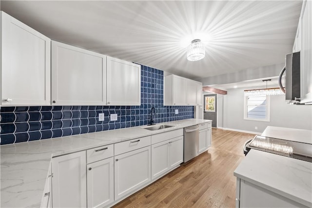 4301 W 74th St, Prairie Village, KS 66208 - kitchen with appliances with stainless steel finishes, white cabinetry, decorative backsplash, light wood finished floors, and light stone countertops