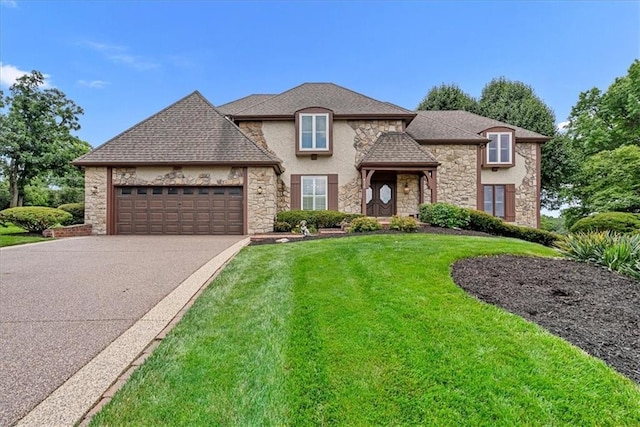 4328 W 110th St, Leawood, KS 66211 - french country home featuring stone siding, a front yard, asphalt driveway, an attached garage, and stucco siding