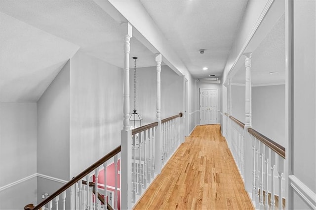 4328 W 110th St, Leawood, KS 66211 - hallway with wood finished floors, a textured ceiling, and an upstairs landing
