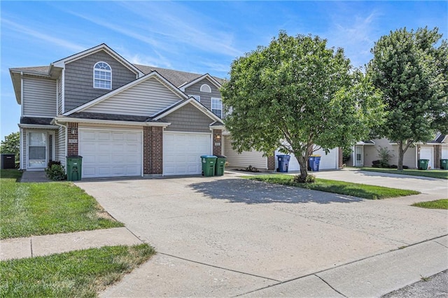 902 SW Peach Tree Ln, Blue Springs, MO 64064 - view of front facade with concrete driveway, brick siding, a garage, and a shingled roof