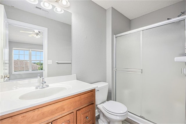 902 SW Peach Tree Ln, Blue Springs, MO 64064 - full bathroom featuring a shower stall, vanity, ceiling fan, a textured ceiling, and a textured wall