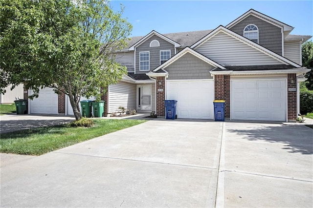 904 SW Peach Tree Ln, Blue Springs, MO 64064 - view of front of property featuring driveway, brick siding, and an attached garage