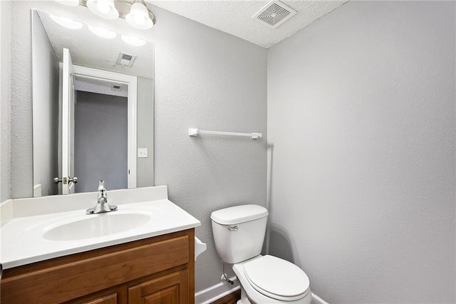 904 SW Peach Tree Ln, Blue Springs, MO 64064 - bathroom featuring vanity, a textured ceiling, and a textured wall