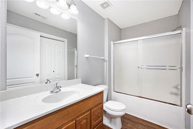 904 SW Peach Tree Ln, Blue Springs, MO 64064 - full bathroom with vanity, wood finished floors, and bath / shower combo with glass door