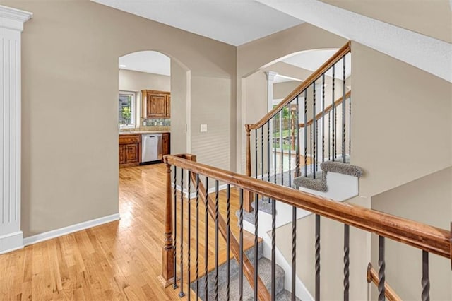 895 N Diane Dr, Olathe, KS 66061 - hall with arched walkways, light wood-type flooring, and stairs