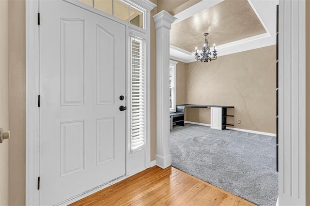 895 N Diane Dr, Olathe, KS 66061 - entrance foyer featuring a chandelier, ornate columns, wood finished floors, carpet floors, and ornamental molding