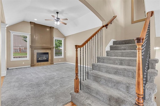 895 N Diane Dr, Olathe, KS 66061 - stairs featuring ceiling fan, lofted ceiling, a tile fireplace, and carpet flooring