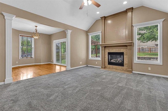 895 N Diane Dr, Olathe, KS 66061 - unfurnished living room with carpet floors, vaulted ceiling, a ceiling fan, a chandelier, and a tile fireplace