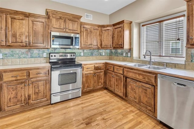 895 N Diane Dr, Olathe, KS 66061 - kitchen featuring appliances with stainless steel finishes, brown cabinets, and light countertops