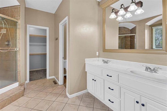 895 N Diane Dr, Olathe, KS 66061 - bathroom with a stall shower, double vanity, tile patterned floors, and a chandelier