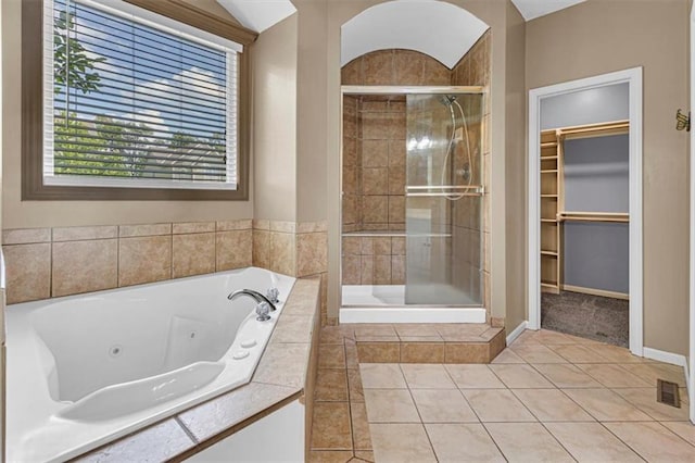 895 N Diane Dr, Olathe, KS 66061 - full bath with a shower stall, a whirlpool tub, a walk in closet, tile patterned floors, and lofted ceiling