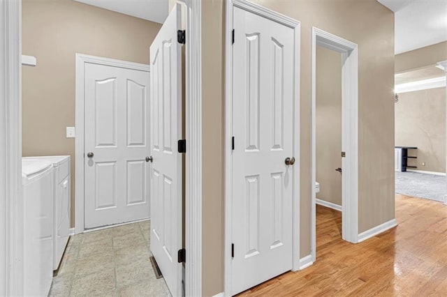 895 N Diane Dr, Olathe, KS 66061 - hallway with washer and clothes dryer and light wood finished floors