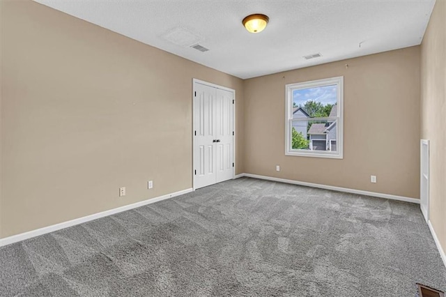 895 N Diane Dr, Olathe, KS 66061 - unfurnished bedroom with carpet floors, a closet, and a textured ceiling