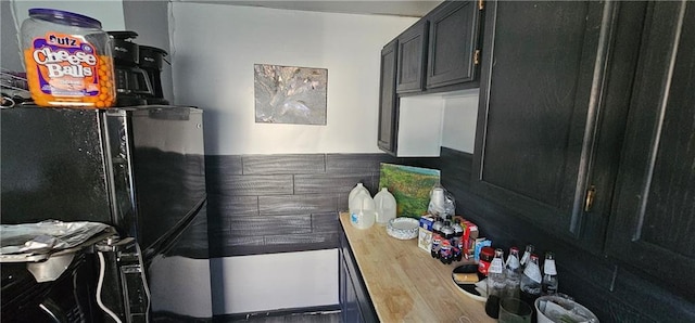 1223 S Delaware Ave, Independence, MO 64055 - kitchen featuring dark cabinets and butcher block countertops