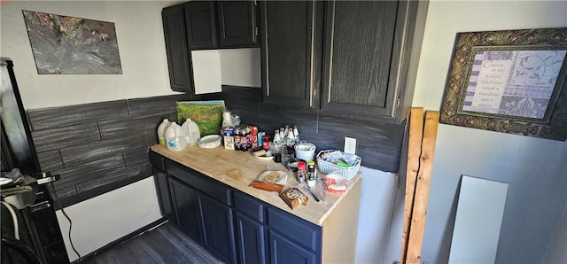 1223 S Delaware Ave, Independence, MO 64055 - kitchen with light countertops, tasteful backsplash, and dark cabinets