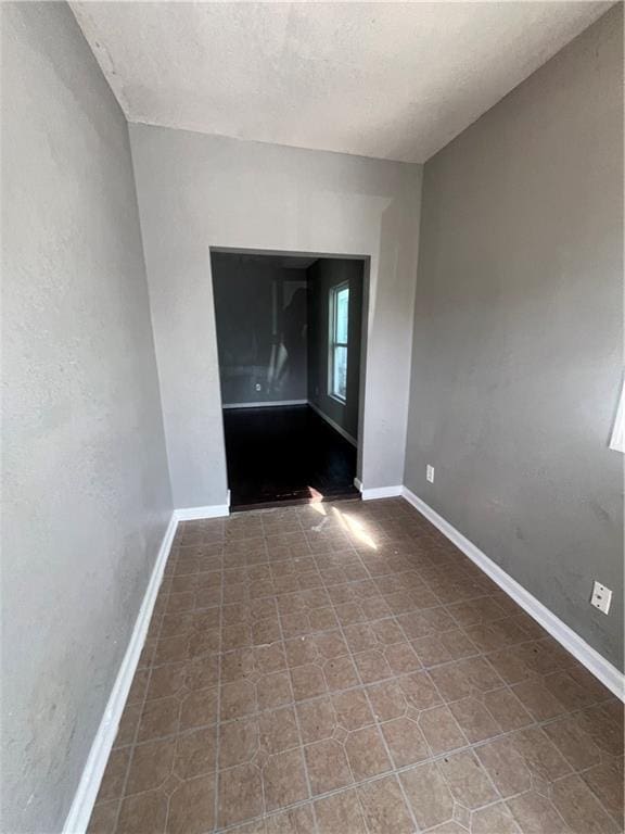 4432 E 10th St, Kansas City, MO 64127 - empty room with baseboards and a textured ceiling