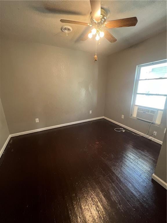 4432 E 10th St, Kansas City, MO 64127 - spare room with cooling unit, dark wood finished floors, and ceiling fan