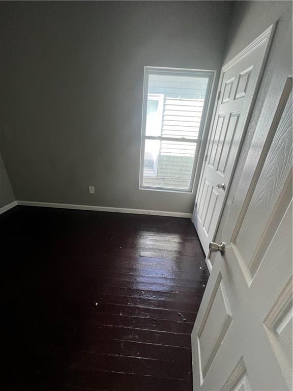 4432 E 10th St, Kansas City, MO 64127 - unfurnished room with dark wood-type flooring and baseboards