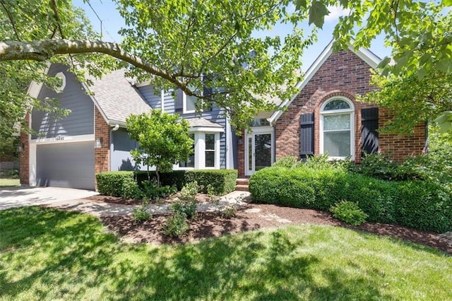 14440 W 187th Ter, Olathe, KS 66062 - view of front of house featuring brick siding, driveway, a garage, a front lawn, and roof with shingles