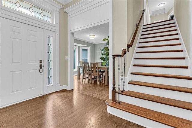 14440 W 187th Ter, Olathe, KS 66062 - entryway featuring wood finished floors, crown molding, and stairway