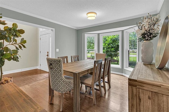 14440 W 187th Ter, Olathe, KS 66062 - dining room featuring wood finished floors, ornamental molding, and a textured ceiling