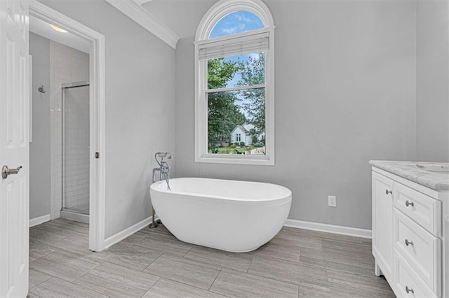 14440 W 187th Ter, Olathe, KS 66062 - bathroom featuring a stall shower, a freestanding tub, vanity, and crown molding