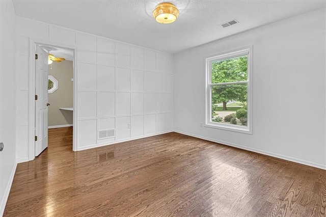 14440 W 187th Ter, Olathe, KS 66062 - empty room with wood finished floors and a textured ceiling