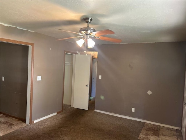 7615 E 48th St, Kansas City, MO 64129 - unfurnished bedroom featuring a closet, a textured ceiling, and ceiling fan