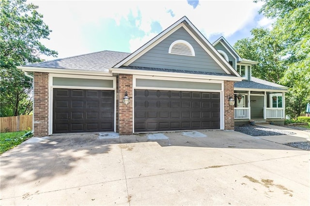 1503 Wrangler Way, Raymore, MO 64083 - view of front of property featuring an attached garage, driveway, a porch, and brick siding