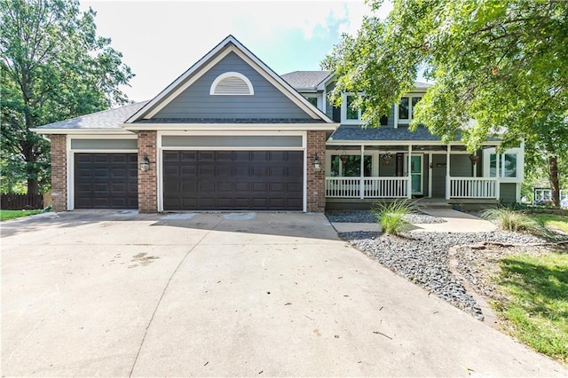 1503 Wrangler Way, Raymore, MO 64083 - view of front of house with a porch, a garage, driveway, and brick siding