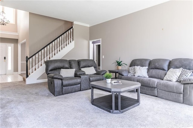 1503 Wrangler Way, Raymore, MO 64083 - carpeted living room with stairs, a chandelier, and crown molding
