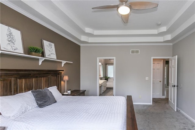 1503 Wrangler Way, Raymore, MO 64083 - carpeted bedroom with a raised ceiling, ceiling fan, and connected bathroom