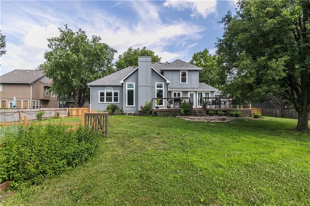 1503 Wrangler Way, Raymore, MO 64083 - rear view of house with a wooden deck, a chimney, and roof with shingles