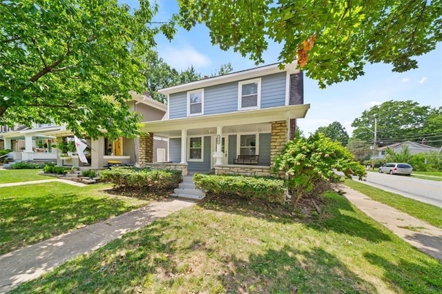 5900 Cherry St, Kansas City, MO 64110 - american foursquare style home with a chimney, a porch, stone siding, and a front yard