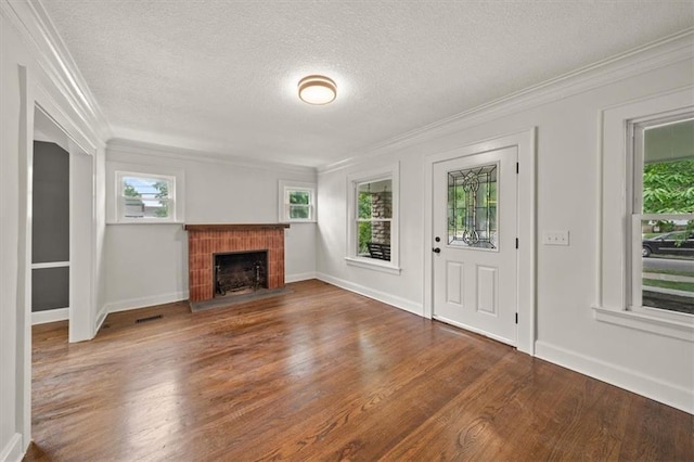 5900 Cherry St, Kansas City, MO 64110 - unfurnished living room with ornamental molding, a textured ceiling, wood finished floors, and a fireplace