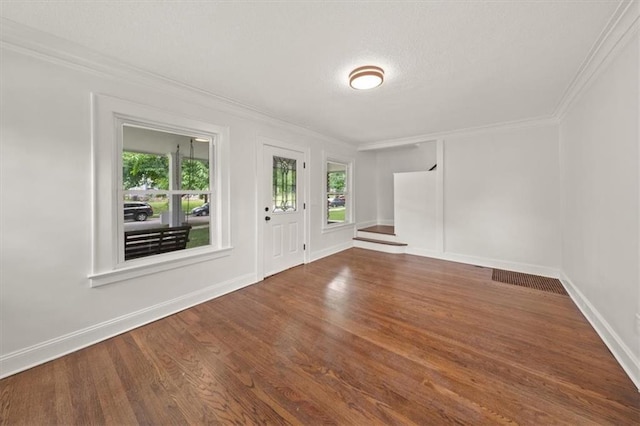 5900 Cherry St, Kansas City, MO 64110 - entryway with ornamental molding, plenty of natural light, wood finished floors, and a textured ceiling