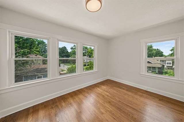 5900 Cherry St, Kansas City, MO 64110 - empty room featuring baseboards and wood finished floors