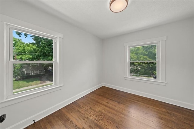 5900 Cherry St, Kansas City, MO 64110 - empty room with dark wood-style floors