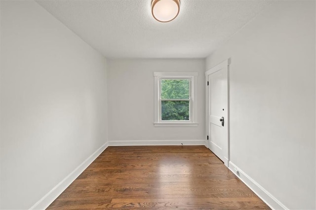 5900 Cherry St, Kansas City, MO 64110 - spare room with a textured ceiling and wood finished floors