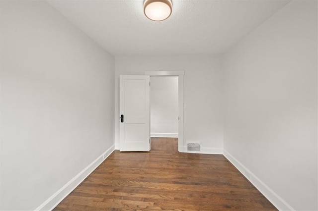 5900 Cherry St, Kansas City, MO 64110 - spare room with dark wood-style floors and a textured ceiling