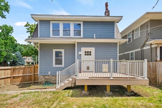 5900 Cherry St, Kansas City, MO 64110 - rear view of property with a wooden deck