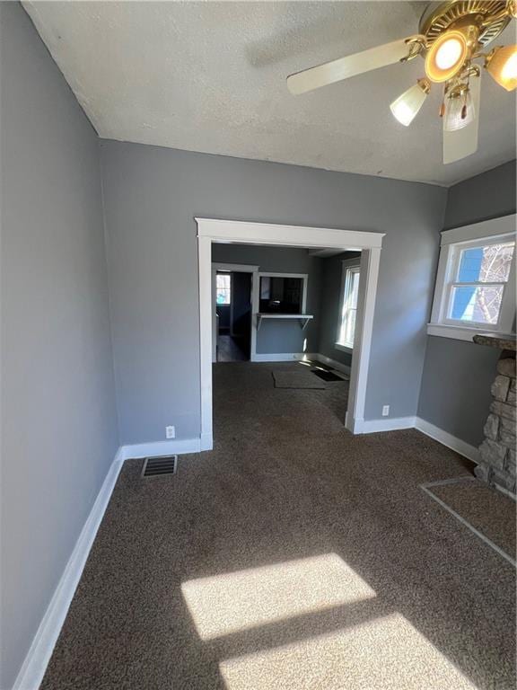 4902 E 17th St, Kansas City, MO 64127 - carpeted spare room with ceiling fan and a textured ceiling